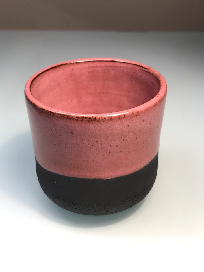 Black clay cup with pink glaze