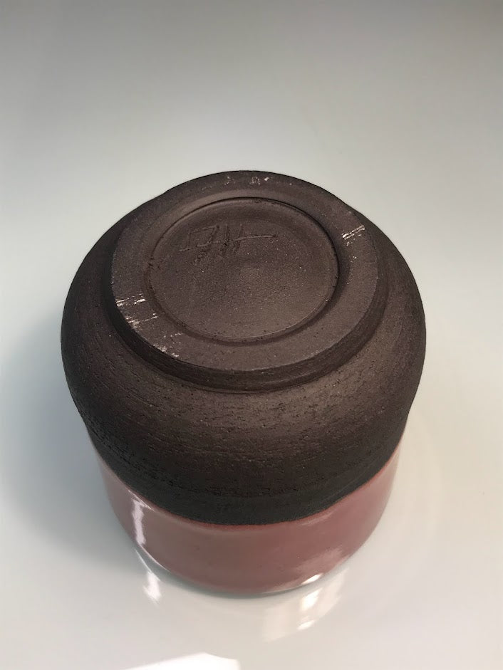 Black clay cup with pink glaze