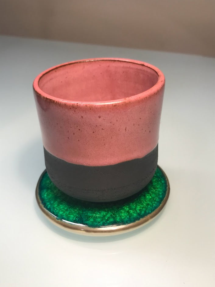 Black clay cup with pink glaze
