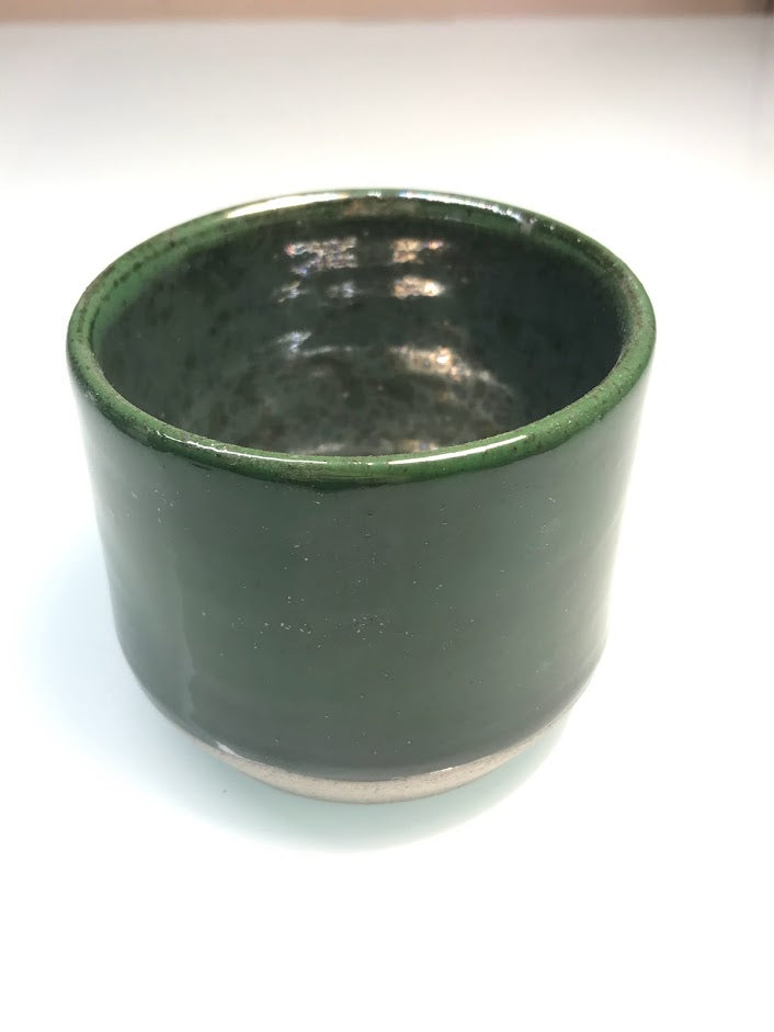 Speckled clay cup with green glaze