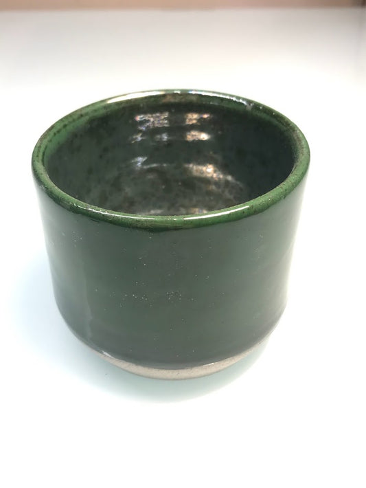 Speckled clay cup with green glaze