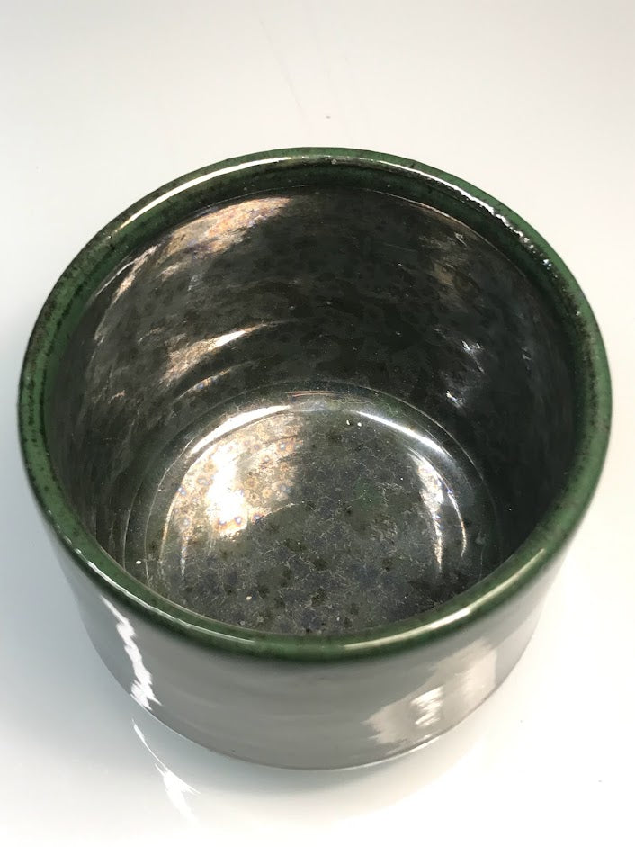 Speckled clay cup with green glaze