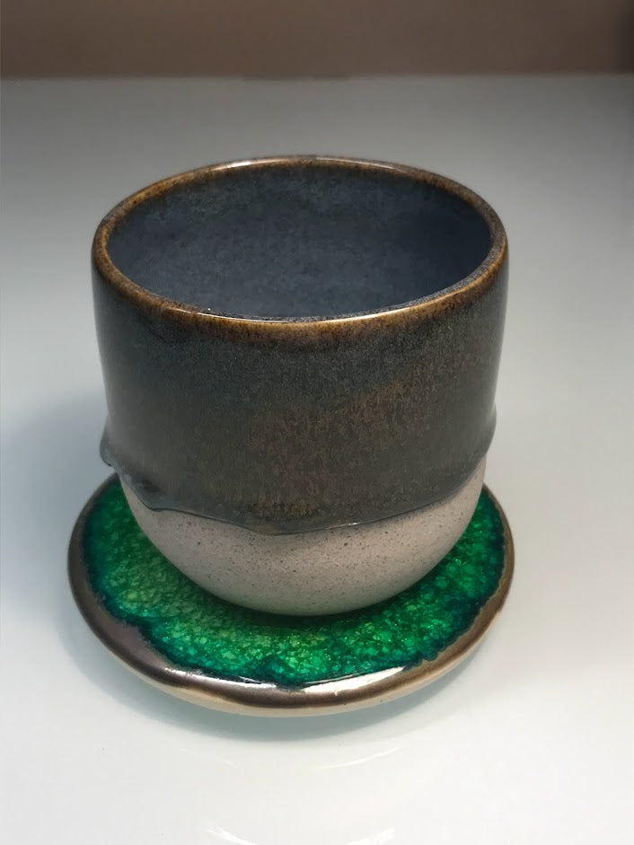 Speckled clay cup with blue and caramel glaze