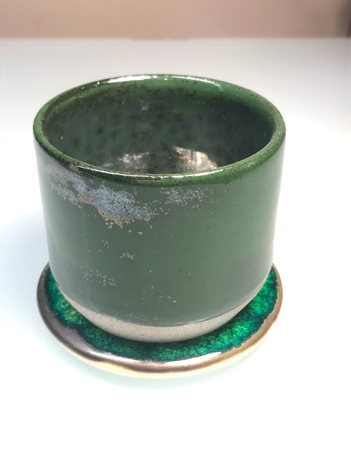 Speckled clay cup with green glaze